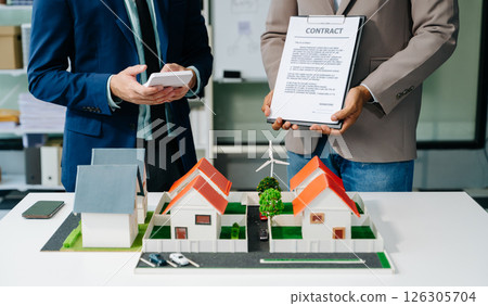 balancing the property sector The real estate agent is explaining the house style to see the house design balancing the property sector The real estate agent is explaining the house style to see the house design 126305704