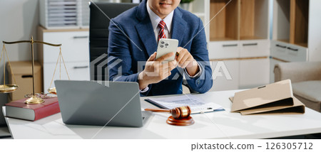 young lawyer in office Business man and lawyers discussing contract papers laptop and tablet with brass scale on  desk 126305712