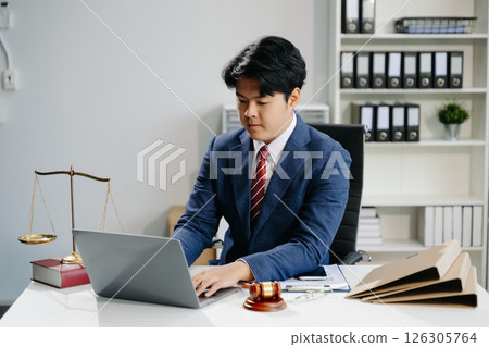 young lawyer in office Business man and lawyers discussing contract papers laptop and tablet with brass scale on  desk 126305764