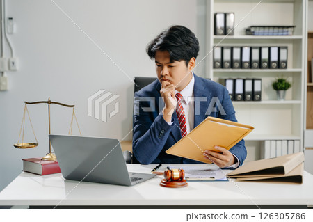 young lawyer in office Business man and lawyers discussing contract papers laptop and tablet with brass scale on  desk 126305786