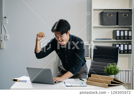 Young business man working at office with laptop, tablet and taking notes on the paper. 126305872