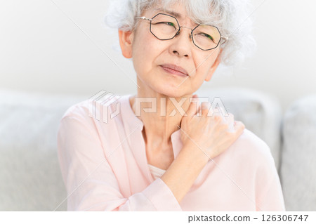 Senior woman suffering from stiff shoulders Senior woman suffering from stiff shoulders 126306747