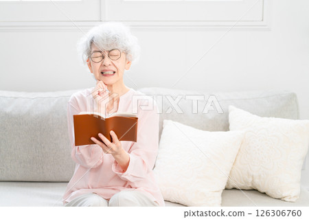 Senior woman looking at her schedule book Senior woman looking at her schedule book 126306760