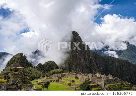 Panoramic view of Machu Picchu ruins surrounded by misty mountains, Peru 126306775