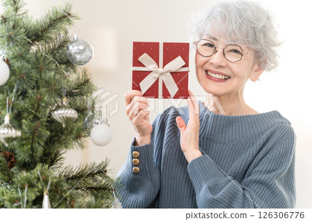 Senior woman holding a Christmas gift 126306776