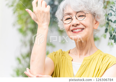 Senior woman wearing a yellow dress Senior woman wearing a yellow dress 126306784