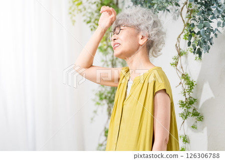 Senior woman wearing a yellow dress Senior woman wearing a yellow dress 126306788