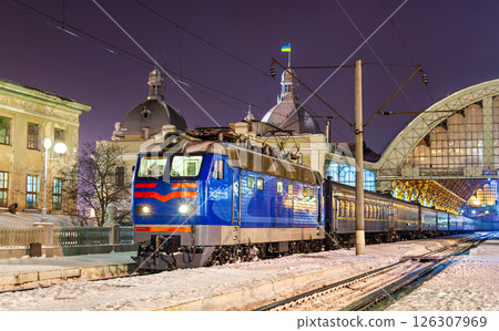 Typical Ukrainian passenger train at Lviv station with Ukraine flag on a winter night 126307969