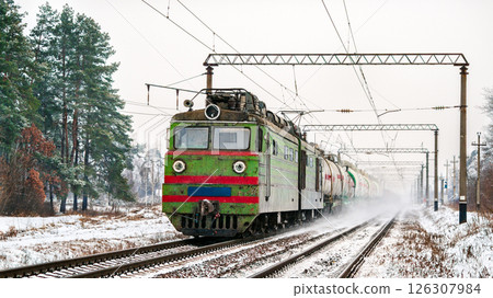 Old Soviet electric locomotive with a heavy freight train in winter in Kyiv Oblast of Ukraine Old Soviet electric locomotive with a heavy freight train in winter in Kyiv Oblast of Ukraine 126307984