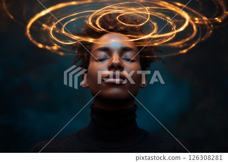 Golden sparkles swirl around a young persons head as they tilt back in peaceful stillness 126308281