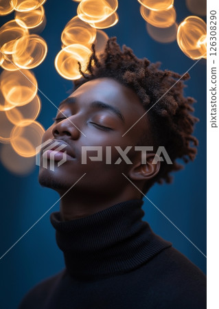 Golden sparkles swirl around a young persons head as they tilt back in peaceful stillness 126308290
