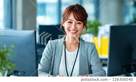 Smiling business woman: Japanese woman working in the office 126308540