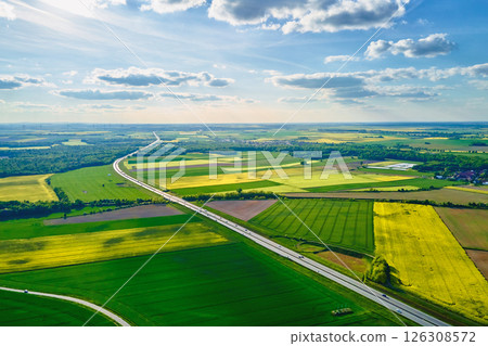 Highway through agricultural fields, aerial view Highway through agricultural fields, aerial view 126308572