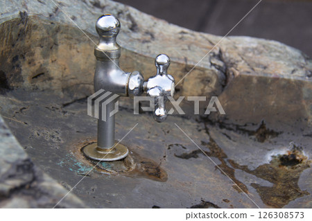 A water pipe with water flowing 126308573