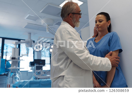 Inappropriate behavior between senior doctor and female nurse. Workplace harassment. Inappropriate behavior between senior doctor and female nurse. Workplace harassment. 126308659