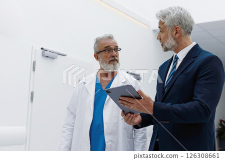 Doctor talking with pharmaceutical representative. Doctor talking with pharmaceutical representative. 126308661