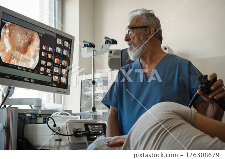 Gastroscopy procedure on sedated patient to examine upper digestive tract. 126308679