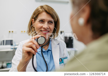 Geriatrician listening to senior patient's heartbeat. 126308714