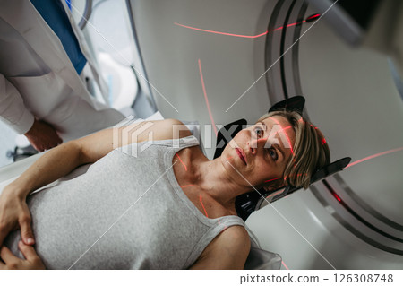 Patient positioned for head scan with laser alignment in CT scanner 126308748