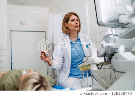 Doctor performing diagnostic ultrasound during preventive care 126308770