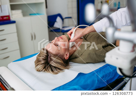Female patient undergoing thyroid ultrasound examination Female patient undergoing thyroid ultrasound examination 126308773