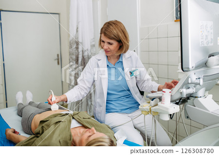 Doctor performing diagnostic ultrasound during preventive care 126308780