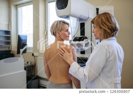 Radiologist comforting patient before mammogram screening. 126308807