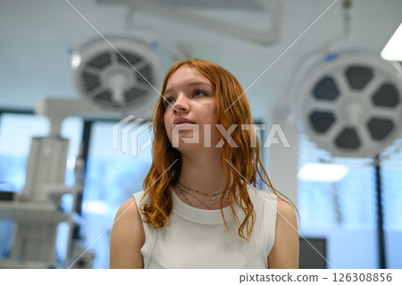 Teenage girl waiting for medical examination in hospital. Teenage girl waiting for medical examination in hospital. 126308856