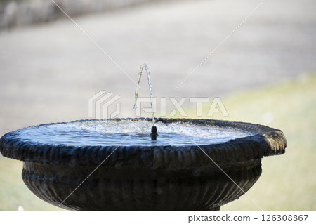 A fountain in a park with strong water flowing 126308867