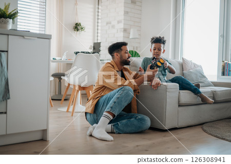 Father and son exploring STEM, robotics, and technology together. 126308941