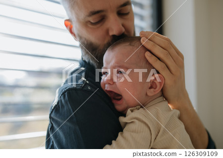 Father comforting his crying baby son. 126309109