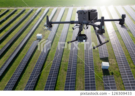 Industrial drone inspects solar panels. 126309433