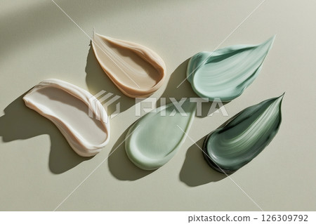 Smooth, colorful pebbles lining a lakes shore, reflecting the warm hues of a vibrant sunset sky 126309792
