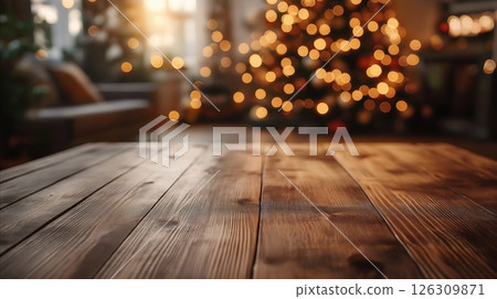 Rich wooden surface with polished planks softly lit by festive Christmas tree lights in background 126309871
