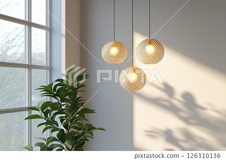 Three round pendant lights with perforated designs cast soft golden illumination near a sunlit window. 126310136