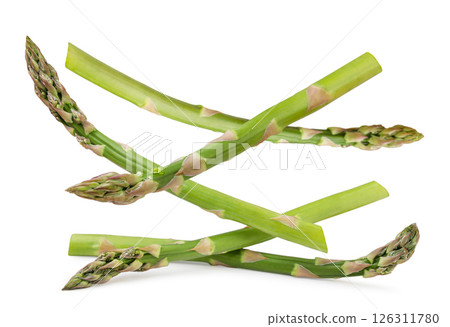 Branches of green asparagus falling on a white background. Isolated Branches of green asparagus falling on a white background. Isolated 126311780