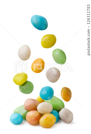 Multicolored glaze dragee falling candies close-up on a white background. Isolated Multicolored glaze dragee falling candies close-up on a white background. Isolated 126311783