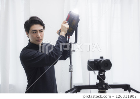 Male cameraman taking a video Male cameraman taking a video 126311902