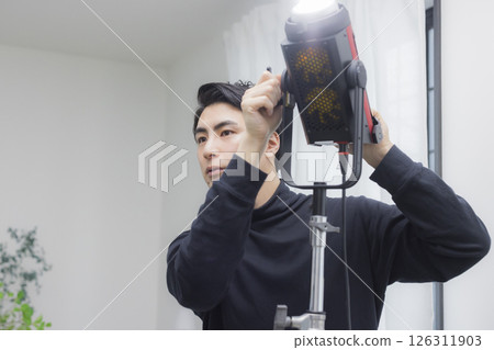 Male cameraman taking a video 126311903