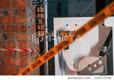 Bomb is planted near fire hose. Explosive is indoors. Police investigation. Conception of terror 126312598