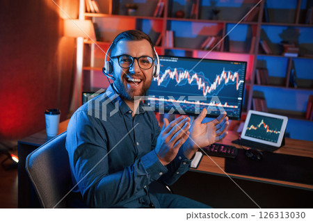 Applauds, conception of success. Stock trader is working by pc indoors. Conception of exchange and money 126313030