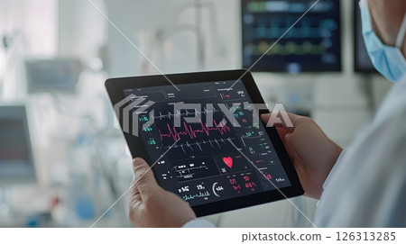 Tablet interface showing heart rhythm and patient stats held by professional doctor, tech-driven hospital environment, 126313285