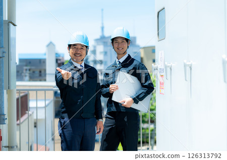 Businessmen in work clothes having a meeting at the site Businessmen in work clothes having a meeting at the site 126313792