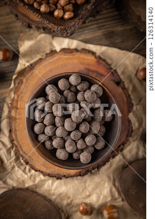 Roasted hazelnuts covered with chocolate Roasted hazelnuts covered with chocolate 126314140