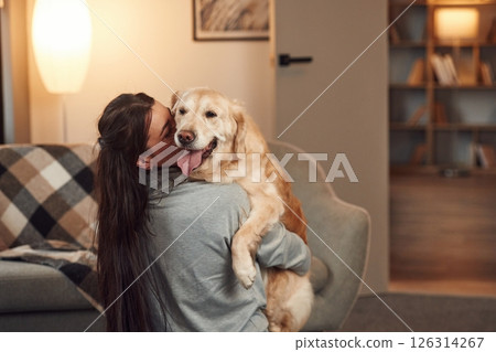 Woman is with golden retriever dog at home Woman is with golden retriever dog at home 126314267