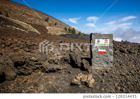 Volcanic landscape indicating monte nero on mount etna with solidified lava, volcanic rocks, and vegetation Volcanic landscape indicating monte nero on mount etna with solidified lava, volcanic rocks, and vegetation 126314435