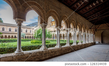 Architectural detail of the cloister of the monreale cathedral, showing arches, columns and the central garden Architectural detail of the cloister of the monreale cathedral, showing arches, columns and the central garden 126314439