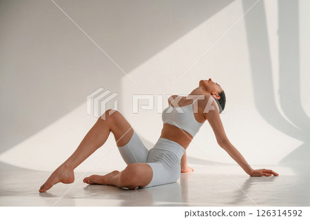Young caucasian woman with slim body shape is indoors in the studio 126314592