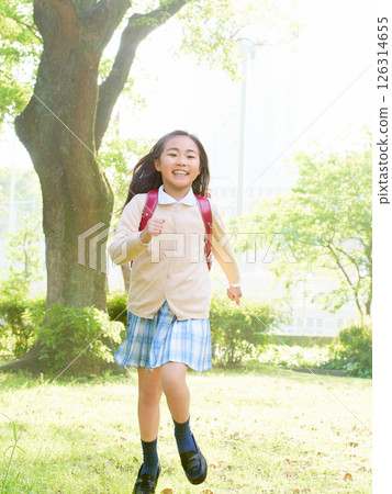 Elementary school girl running with school bag 126314655