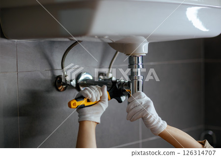 Tightening Drain Pipe Under Sink Tightening Drain Pipe Under Sink 126314707